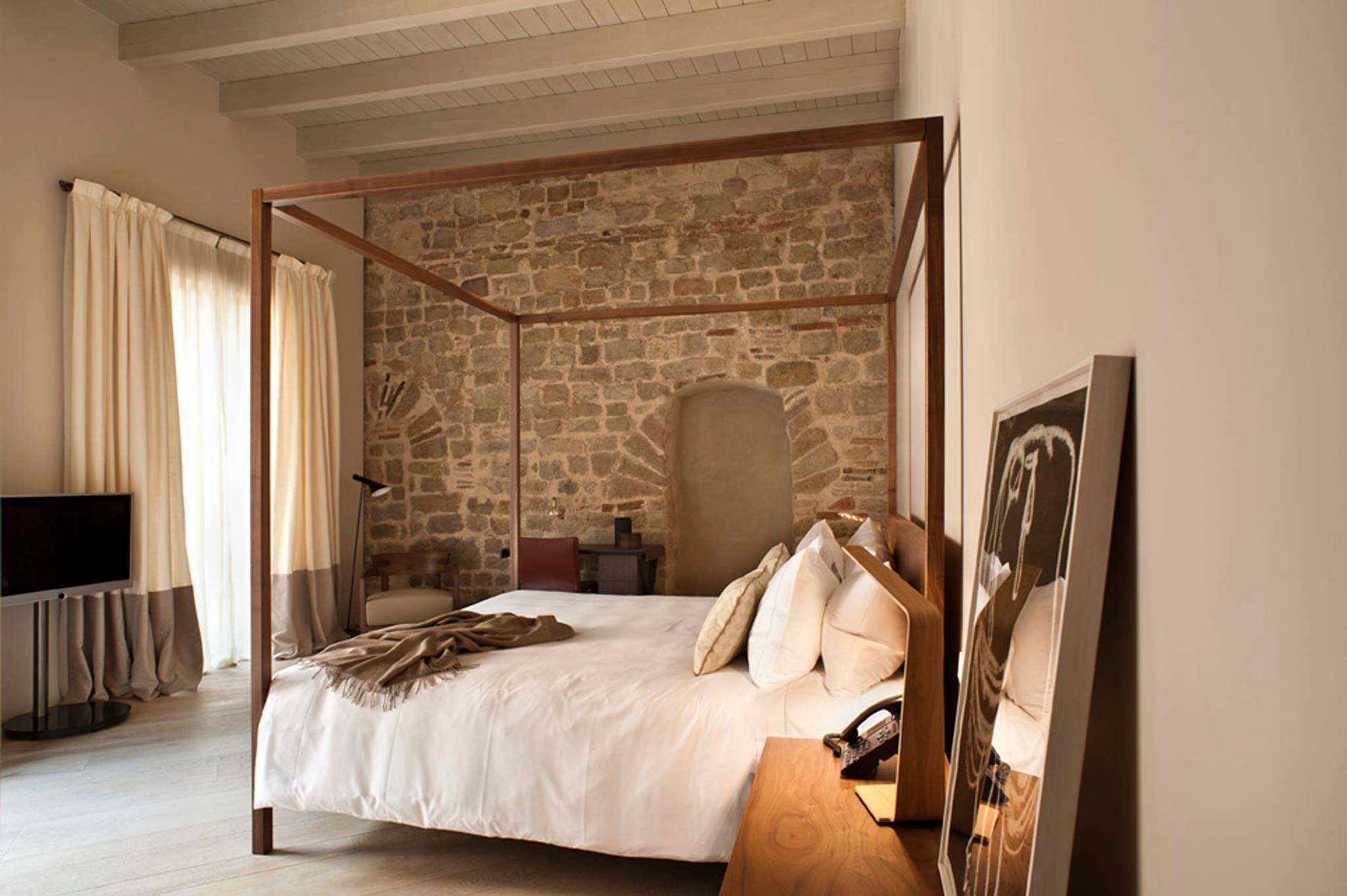 Mercer Hotel's historic rooms with old walls form one of the bedrooms of this boutique htoels in Barcelona bedroom