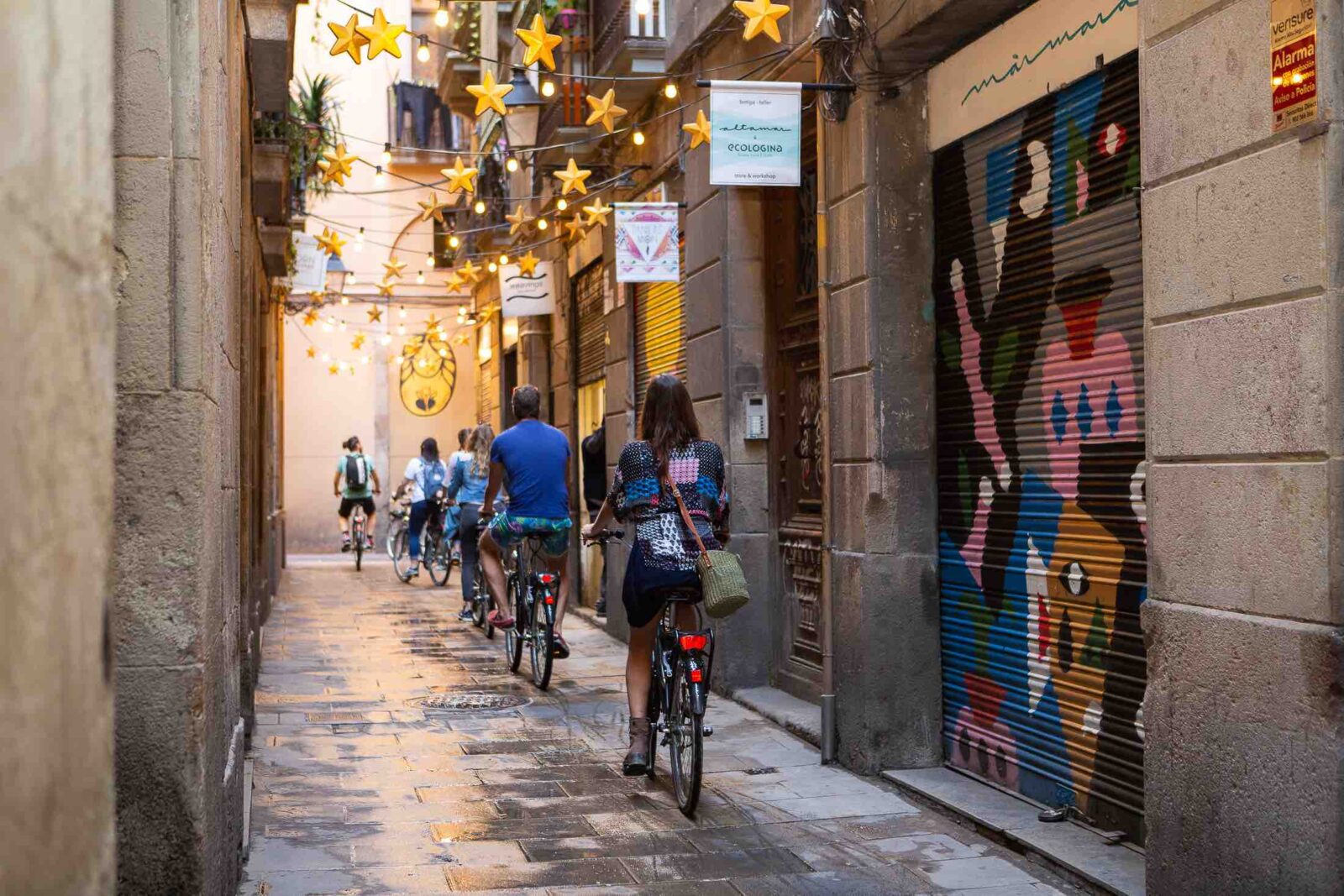 Woman enjoying a Baarcelona bike tour in a quiet alley-cropped