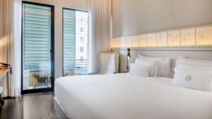 The Cotton house hotel with bedroom seen here is one of the top historic hotels in Barcelona